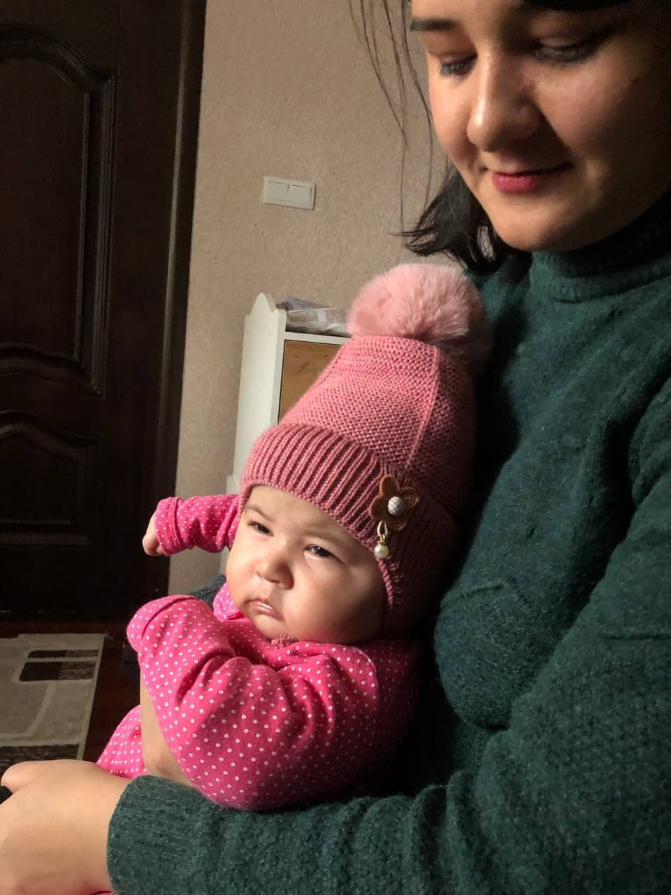 Мижгона держит малышку Алию